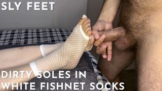 Sleazy soles in white fishnet socks get covered with spunk